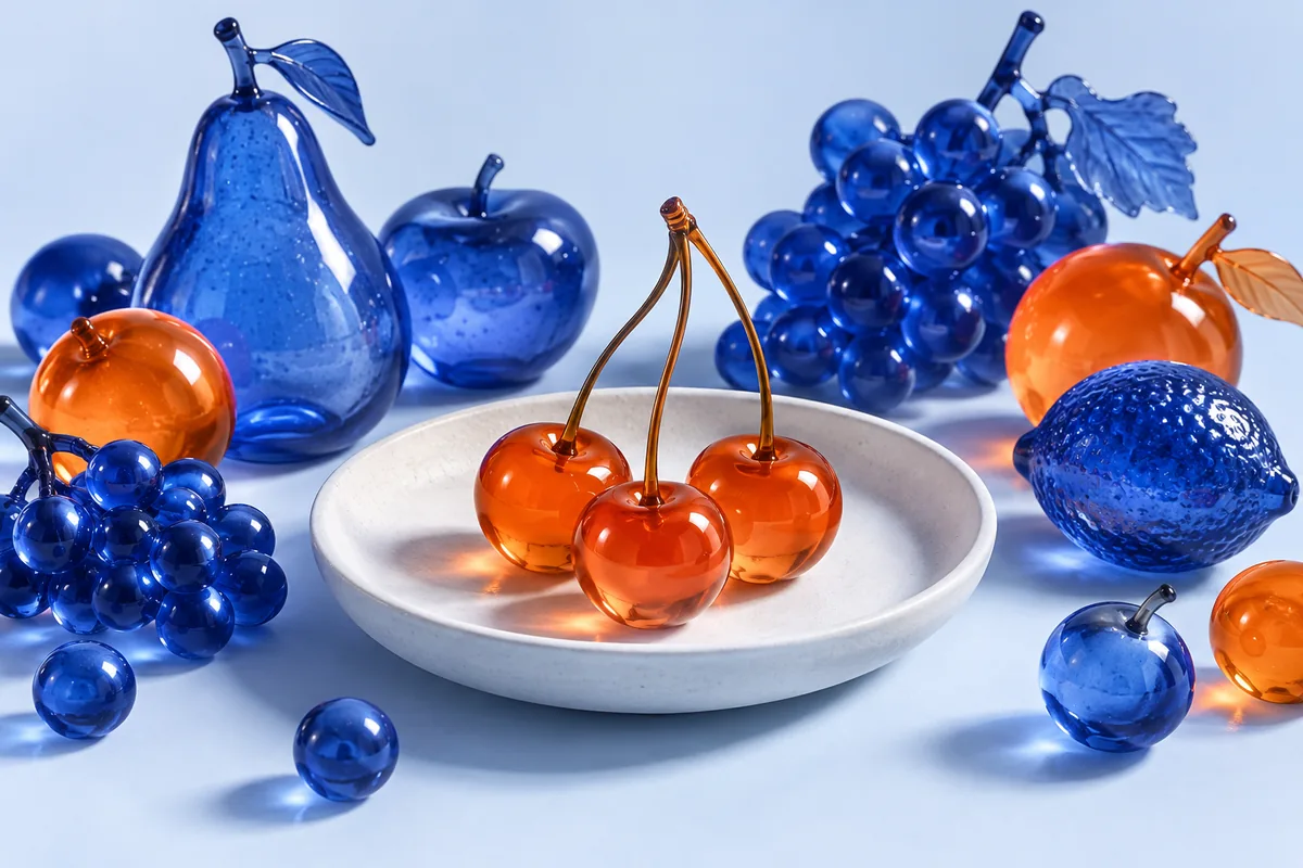 Selected orange glass cherries beside a mixed collection. AI-created editorial illustration.