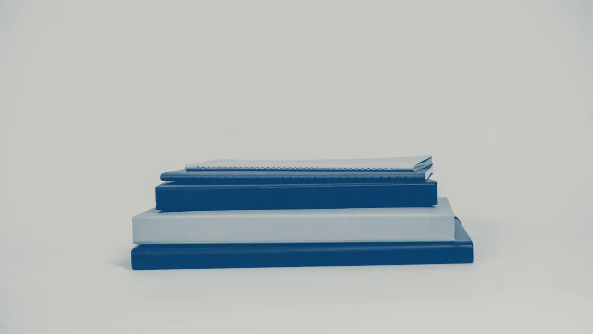 A small stack of bound volumes on a plain surface.